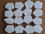 many white buttons that are on a brown surface