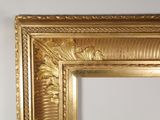 a picture of a gold framed mirror on the wall