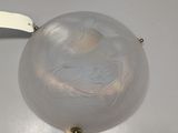 a glass bowl with a white handle on a table