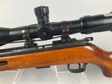 a close up of a rifle with a scope mounted on it