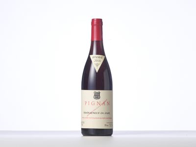a bottle of red wine sitting on top of a table