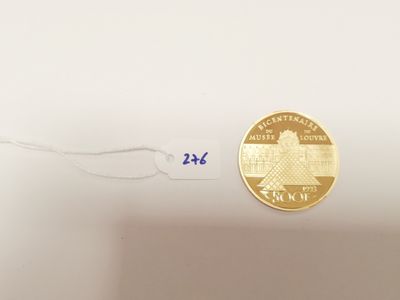 an image of a gold coin with a small piece of paper attached to it