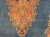 an antique persian rug with a medallion design on a blue ground