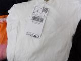 a white t - shirt with a price tag on it
