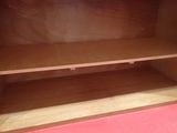 a wooden cabinet with a shelf in the middle
