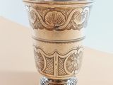 a silver cup sitting on top of a table
