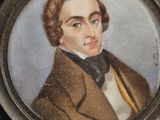 portrait of a man in a brown coat and bow tie