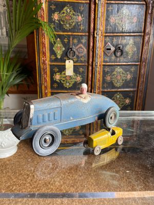 a blue toy car and a yellow toy car on a table