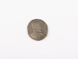 an old coin on a white surface with a white background