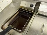 a deep fryer in the middle of a kitchen