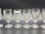 six wine glasses are lined up on a table with a price tag