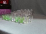 a lot of glasses sitting on a table next to each other