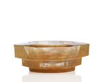 a wooden bowl that is sitting on a white surface