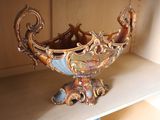 a decorative bowl sitting on a shelf in a room