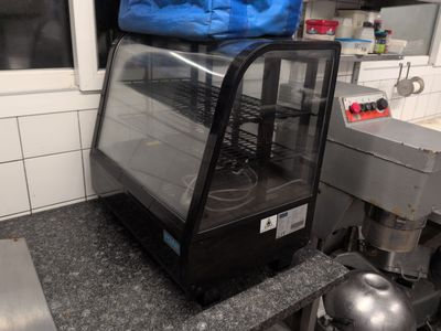 an image of a kitchen with a counter top and a glass case
