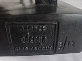 a close up of a black object on a white surface