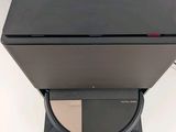 a laptop computer sitting on top of a stand
