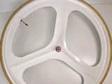 a white plate with a wooden rim on a white surface