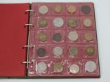 a red book with a bunch of coins inside of it