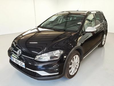 the black volkswagen golf is parked in a white room