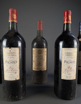 four bottles of wine are lined up on a table
