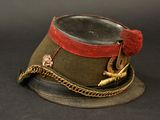 a hat with a chain around it on a black surface