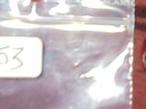 un petit piment rouge dans un sac en plastique posé sur une table