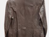the back of a brown leather jacket hanging on a hanger