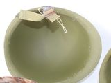 two green bowls sitting next to each other on a table