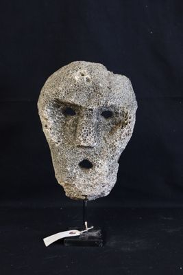 an image of a stone face on a black background