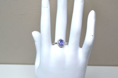 a hand with a ring that has a tan sapphire on it