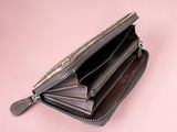 leather wallet on a pink background with one open and the other closed