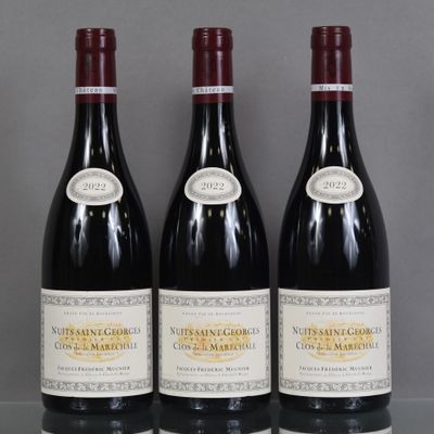 three bottles of wine are lined up on a table