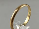 a close up of a gold ring on top of a clear glass