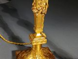 a gold lamp that is sitting on a table