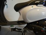 a motor scooter that is parked in a garage