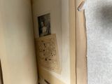 an open book with pictures on it sitting on a table