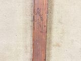 a baseball bat that has been left on the ground