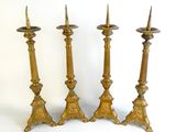 three brass candlesticks are sitting next to each other