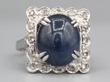 an image of a ring with a blue star sapphire stone in it