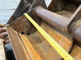 a close up of a construction equipment with a measuring tape on it