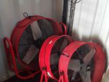 deux ventilateurs rouges placés l'un à côté de l'autre dans une pièce