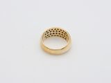 a yellow gold ring with holes in the middle of it