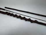 two old canes are sitting on a white surface
