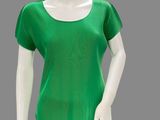 the mannequin is wearing a green top and black pants