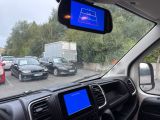 a car that is driving down the street with a blue screen
