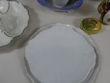 a table with a plate, bowl, and cups on it