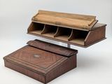 an old wooden desk with a wooden box on top of it