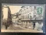 an old photo of a street in the middle of town