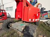 a red crane that is parked in front of a building